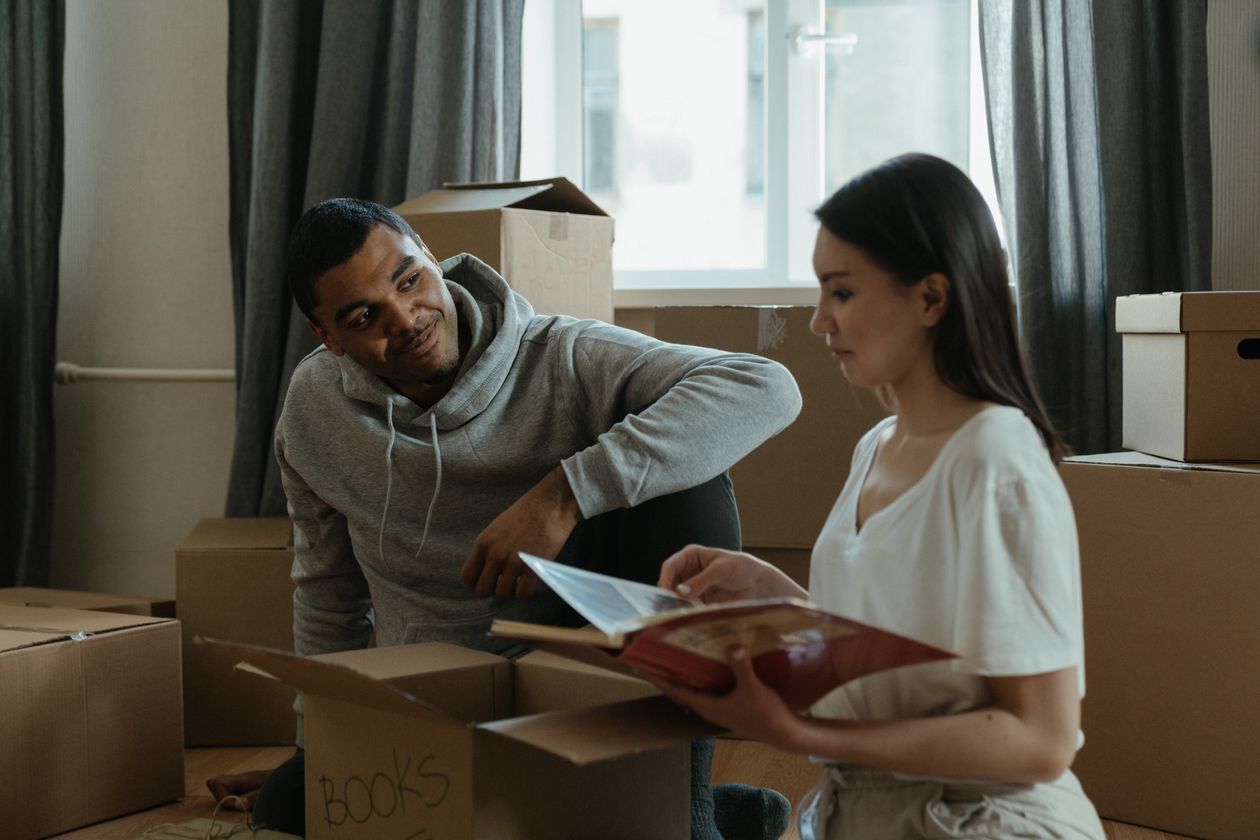 A couple unpacking boxes and settling into their new home